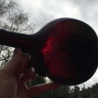 English lenticular bottle, in dark garnet red glass - XIXth Glassware