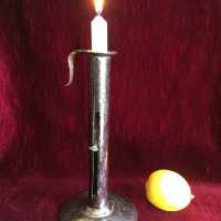 Candlestick in wrought iron sheet, "up and down" system, open cylindrical body of a "light" letting slide a thumb connected to the spring allowing a cup to mount the candle as it burns