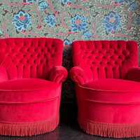 pair red velvet padded armchair