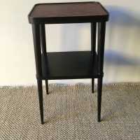 Elegant pedestal table in blackened wood and upper tray in red leather
