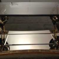 Table basse en bois sculpté et argenté à la feuille, bec et pattes en bronze 1980
