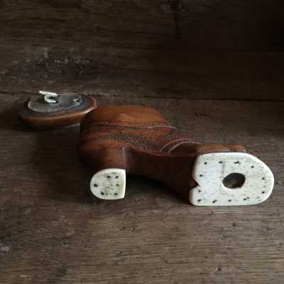 Two small dices encased under the glass under the bone sole