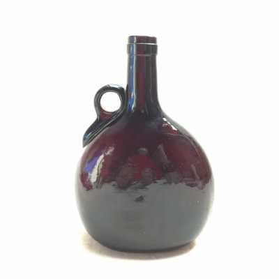 Molded blown bottle. Annular handle reported hot.