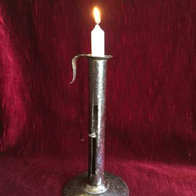 Candlestick in wrought iron sheet, "up and down" system, the upper circular part retaining the wax which surmounts the cylinder is monoxyle with the gripping hook
