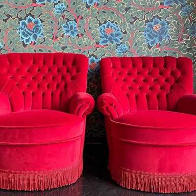 pair red velvet padded armchair