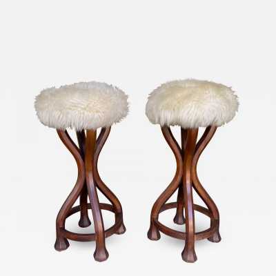 Pair of bar stools in wood and sheepskin. italy 1970 in Art Nouveau style, Art Deco 1940, 1950, 1960, Mid-Century Modern mood. armchairs chairs poufs table side tables lamps floor lamp sconces