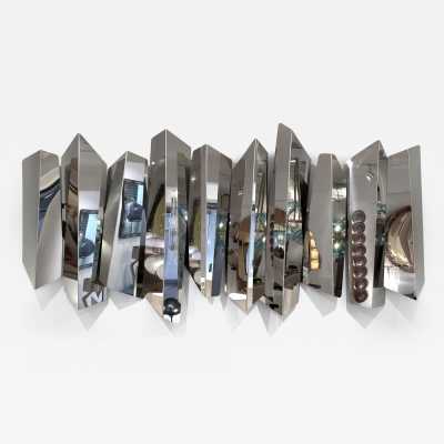 Large polished stainless steel metal wall lamp by Mario Torregiani. Italy 1990. in the style of Aldo Nason, Poliarte, Esperia, Angelo Brotto, Stilnovo, Arteluce, Arredoluce, Artemide, Pierre Cardin, Lumi, Luci, Raak, Angelo Lelii, Francesco Bocola, Superstudio, Enrico Tronconi, Mario Bellini, Harvey Guzzini , Luigi Massoni, Martinelli, Fabio Lenci, Gio Ponti, Sciolari, Willy Rizzo, Reggiani. lamp wall lightning chandelier sconces chrome stainless steel brass mid-century modern space age italy 1970 1980