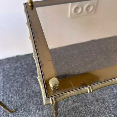 Set of three bamboo nesting or stacking tables, Mid-Century Modern style, in gilded bronze with smoked glass top, by the French manufacturer Maison Baguès. Famous houses such as Maison Jansen, Roger Robert Thibier, Charles, Ramsey and Romeo Rega were also represented.