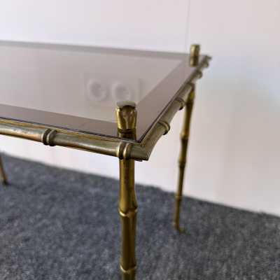 Set of three bamboo nesting or stacking tables, Mid-Century Modern style, in gilded bronze with smoked glass top, by the French manufacturer Maison Baguès. Famous houses such as Maison Jansen, Roger Robert Thibier, Charles, Ramsey and Romeo Rega were also represented.