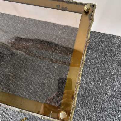 Set of three bamboo nesting or stacking tables, Mid-Century Modern style, in gilded bronze with smoked glass top, by the French manufacturer Maison Baguès. Famous houses such as Maison Jansen, Roger Robert Thibier, Charles, Ramsey and Romeo Rega were also represented.