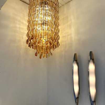 Hollywood Regency cascading wave chandelier mid-century modern space age, clear amber Murano glass pendant and gold metal frame by Mazzega Manufacture, design attributed to Carlo Nason. Famous manufactory such as Venini, Veronese, La Murrina, Aldo Nason, Stilnovo, Joe Colombo, Arteluce, Arredoluce, Lumi, Luci, Rggiani, Sciolari, Werner Pantone, Luigi Colani, Raak, Angelo Lelii, Angelo Brotto, Esperia, Francesco Bocola, Superstudio, Enrico Tronconi, Mario Bellini, Harvey Guzzi