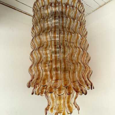 Hollywood Regency cascading wave chandelier mid-century modern space age, clear amber Murano glass pendant and gold metal frame by Mazzega Manufacture, design attributed to Carlo Nason. Famous manufactory such as Venini, Veronese, La Murrina, Aldo Nason, Stilnovo, Joe Colombo, Arteluce, Arredoluce, Lumi, Luci, Rggiani, Sciolari, Werner Pantone, Luigi Colani, Raak, Angelo Lelii, Angelo Brotto, Esperia, Francesco Bocola, Superstudio, Enrico Tronconi, Mario Bellini, Harvey Guzzi