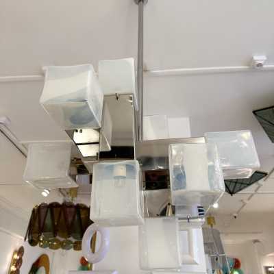 Cube-shaped pendant chandelier in blue opaline Murano glass and chrome-plated metal, manufactured by Mazzega. Designs by major brands such as Venini, Vistosi, La Murrina, Poliarte, Carlo Aldo Nason, and Toni Zuccheri.