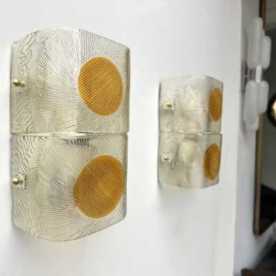 Pair of mid-century modern space age wall sconces in orange and clear textured Murano glass by the Mazzega factory. Famous Italian design like Venini, Vistosi, La Murrina, Aldo Carlo Nason, Toni Zuccheri, Stilnovo, Joe Colombo, Arteluce, Arredoluce, Lumi, Luci, Rggiani, Sciolari, Werner Pantone, Luigi Colani, Raak, Angelo Lelii, Angelo Brotto, Esperia, Francesco Bocola, Superstudio, Enrico Tronconi, Mario Bellini, Harvey Guzzini, Luigi Massoni, Martinelli, Pierre Cardin, Fabio Lenci, Gi