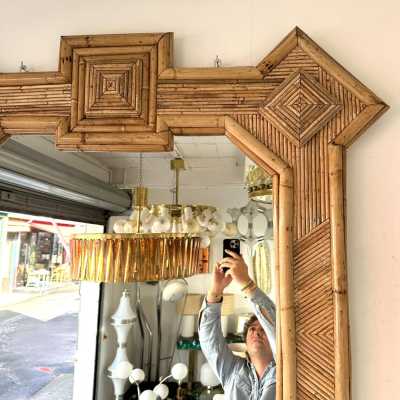 Large mid-century Hollywood Regency wall mirror made of bamboo, rattan, raffia, and wicker by the Italian manufacturer Vivai del Sud. Original manufacturer stamp on the back. Famous designs by Maison Arpex International, Dal Vera, Renato Zevi, Romeo Rega, Maison Jansen, brass palm, and Mario Sabot.