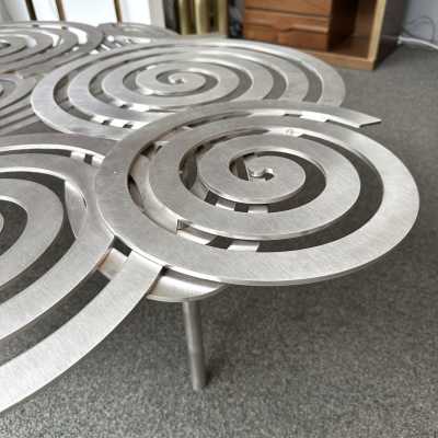 Large, contemporary spiral stainless steel coffee table by Italian artist-designer Antonio Cagianelli. Handcrafted, signed and dated 2024 with the AC monogram. Limited edition of eight. Some of Antonio Cagianelli's works are housed at the Musée des Arts Décoratifs in Paris.