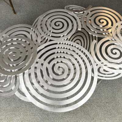 Large, contemporary spiral stainless steel coffee table by Italian artist-designer Antonio Cagianelli. Handcrafted, signed and dated 2024 with the AC monogram. Limited edition of eight. Some of Antonio Cagianelli's works are housed at the Musée des Arts Décoratifs in Paris.