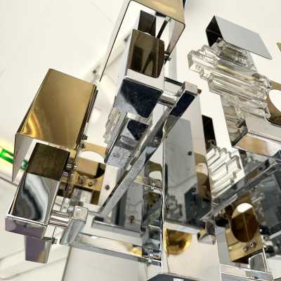 Space Age-style pendant chandelier, Mid-Century Modern design, designed by Italian designer Gaetano Sciolari for one of his editors, Stilkronen. Chrome-plated metal, brass, and glass. Famous designs: Reggiani, Stilux, and Esperia.