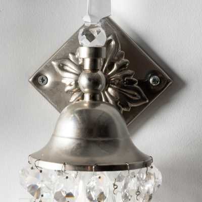 Front detail of a "Libertine" wall light by Mark Brazier-Jones: diamond-shaped base, foliate rosette, and bell-shaped shade.