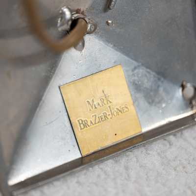 Brass label "Mark Brazier-Jones" on the back of the mounting bracket for a "Libertine" wall light