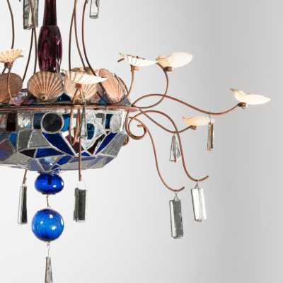 Detail of the Dubreuil and Dixon chandelier: wrought iron arm with shell motifs, glass bowl and led mirrors