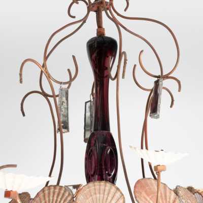 Detail of the Dubreuil and Dixon chandelier: violet glass stem, wrought iron arm and shells