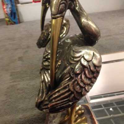 Table basse en bois sculpté et argenté à la feuille, bec et pattes en bronze 1980